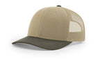Angled three-quarter view of a Richardson 112 trucker hat with a solid khaki front and bill, paired with chocolate chip desert camo mesh side panels.